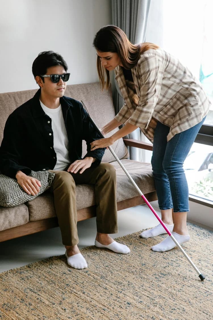 Young adult support worker assisting a person with disability